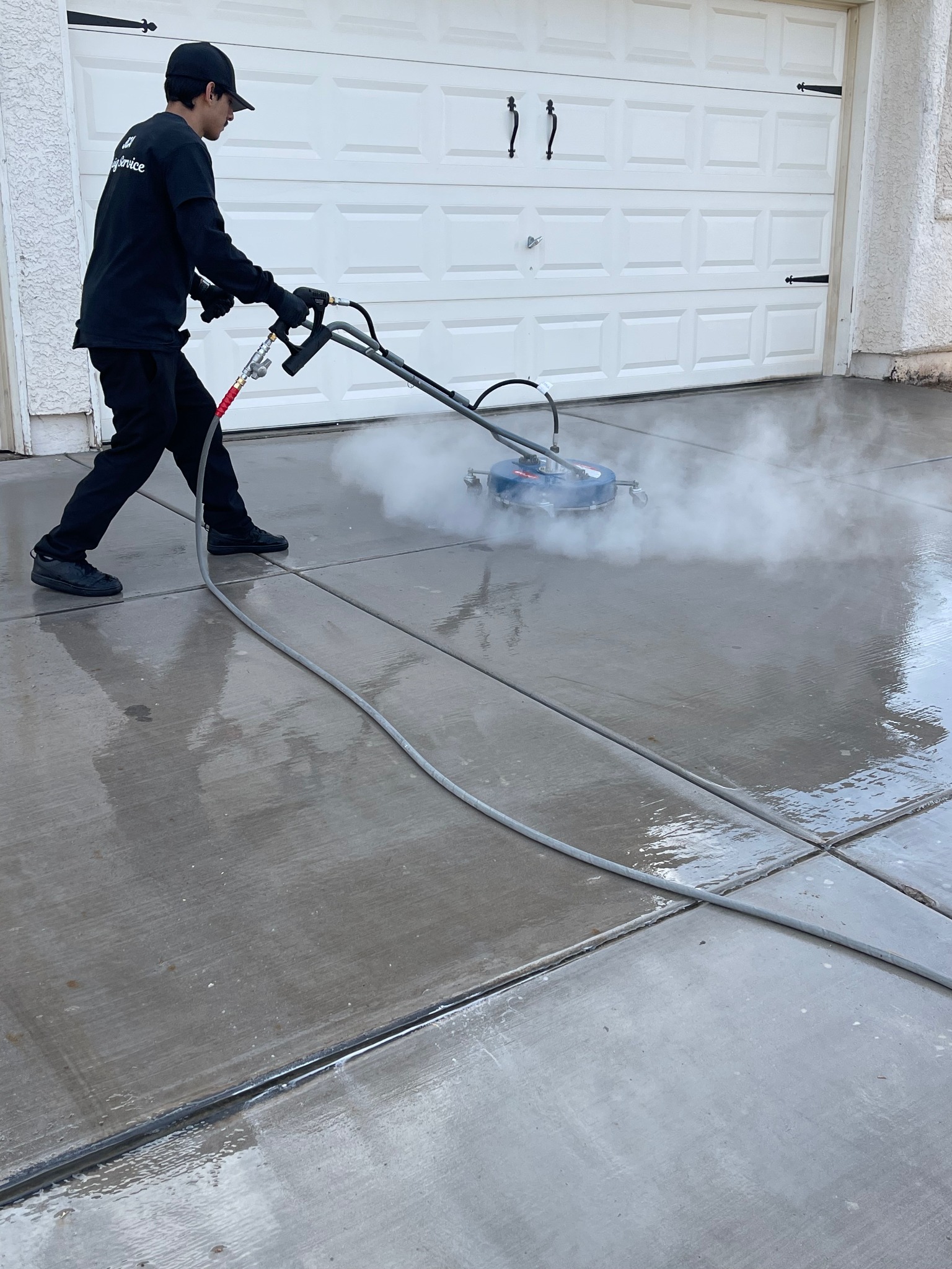 JCA hot water pressure washing in use on exterior concrete