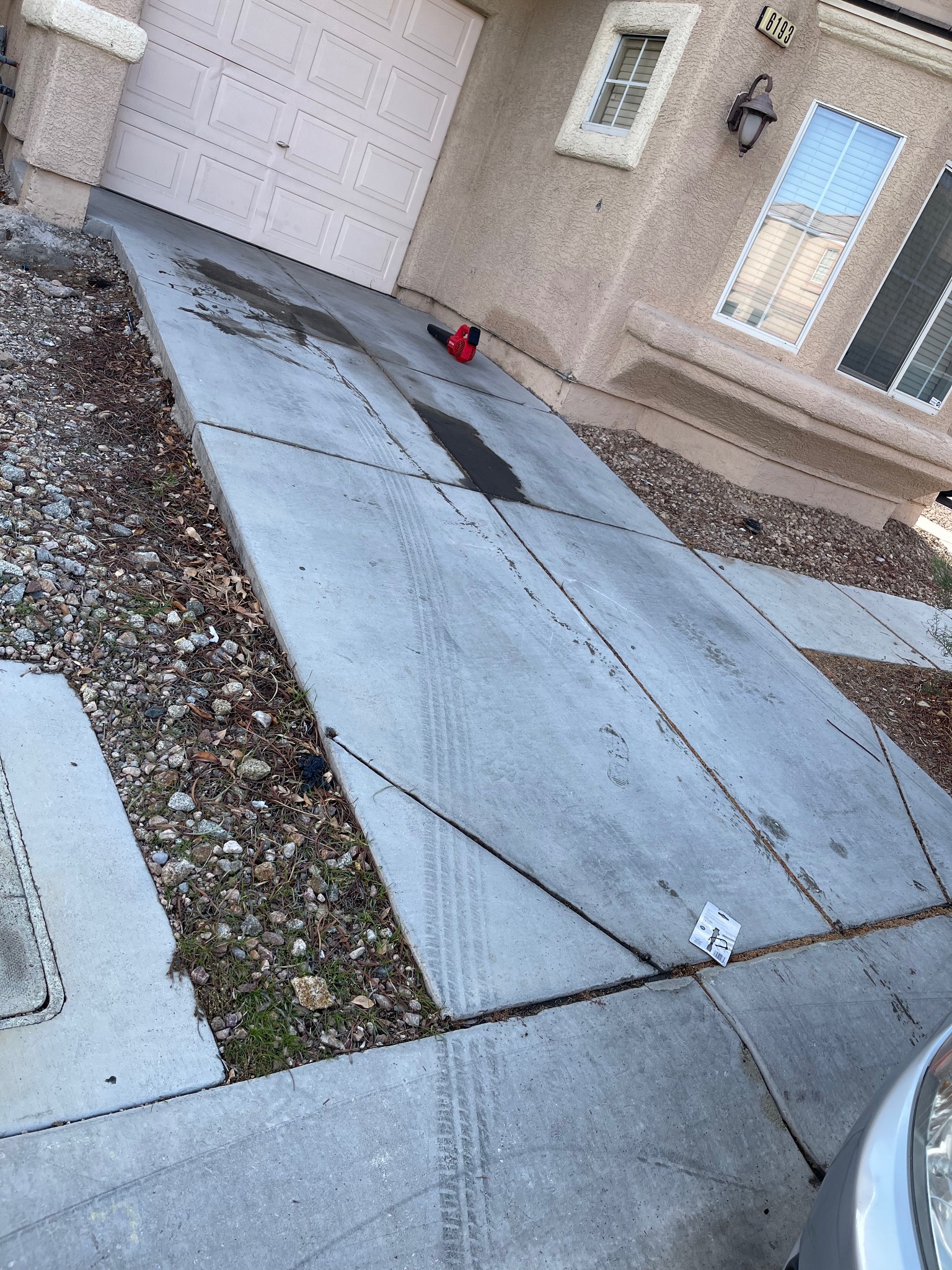 Automotive-fluid staining visible on concrete before treatment